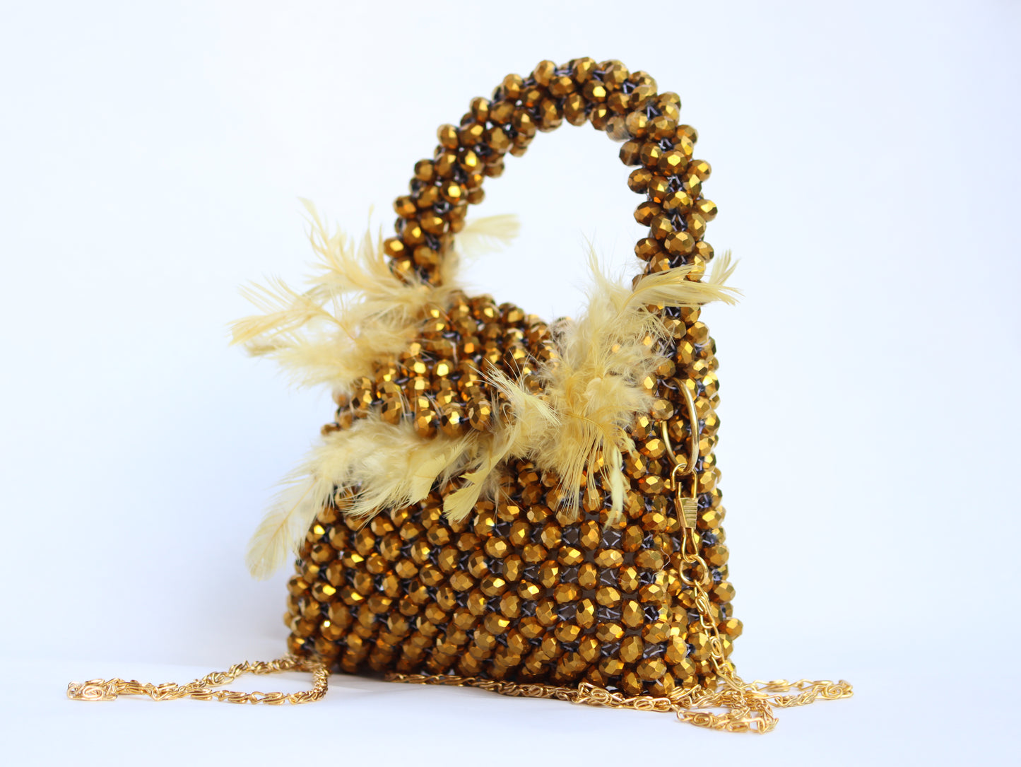 Lily mini handbag adorned with delicate beads and feathers designed.