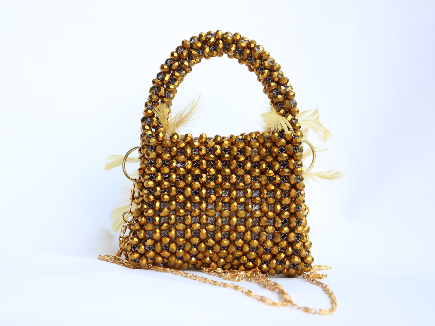 Lily mini handbag adorned with delicate beads and feathers designed.
