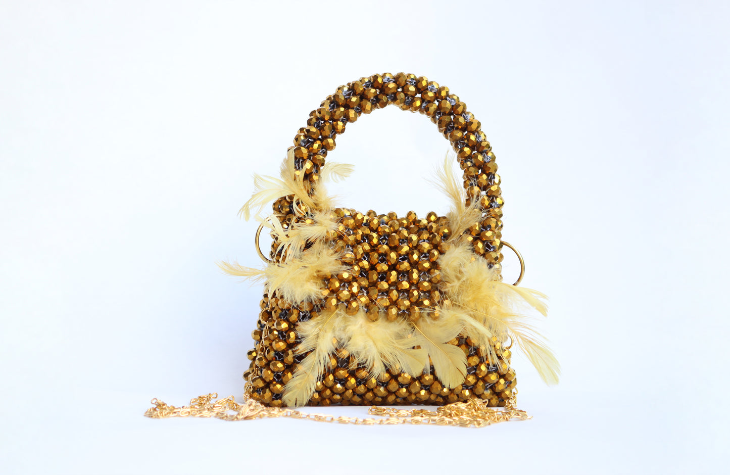 Lily mini handbag adorned with delicate beads and feathers designed.